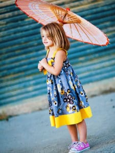 little girl wearing a gray and yellow dress for toddlers